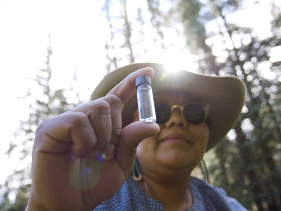 Woman holding a water sample
