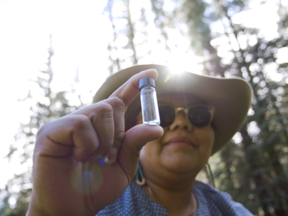 Woman holding a water sample